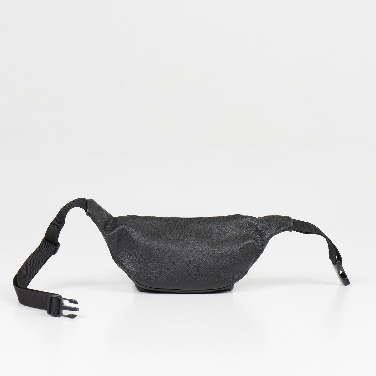 4. Flat lay of black leather waist bag with adjustable strap and buckle on white background