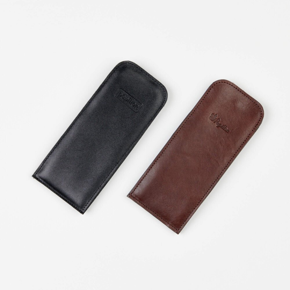 1. Papillon leather glasses cases in black and brown, shown in a flat lay