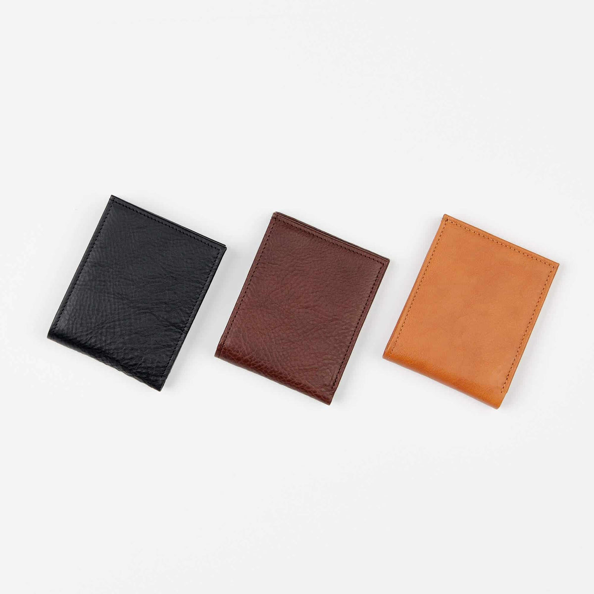 7. Trio of Papillon leather wallets in black, brown, and tan, shown in flat lay