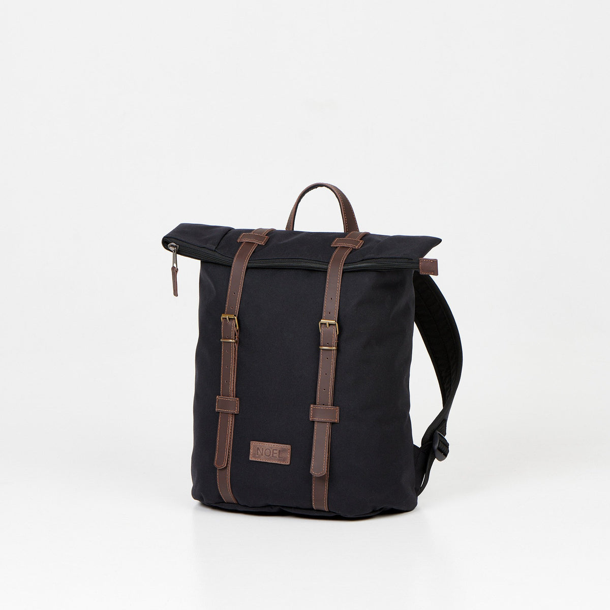 5. Angled view of Noel black zip backpack with leather straps in studio