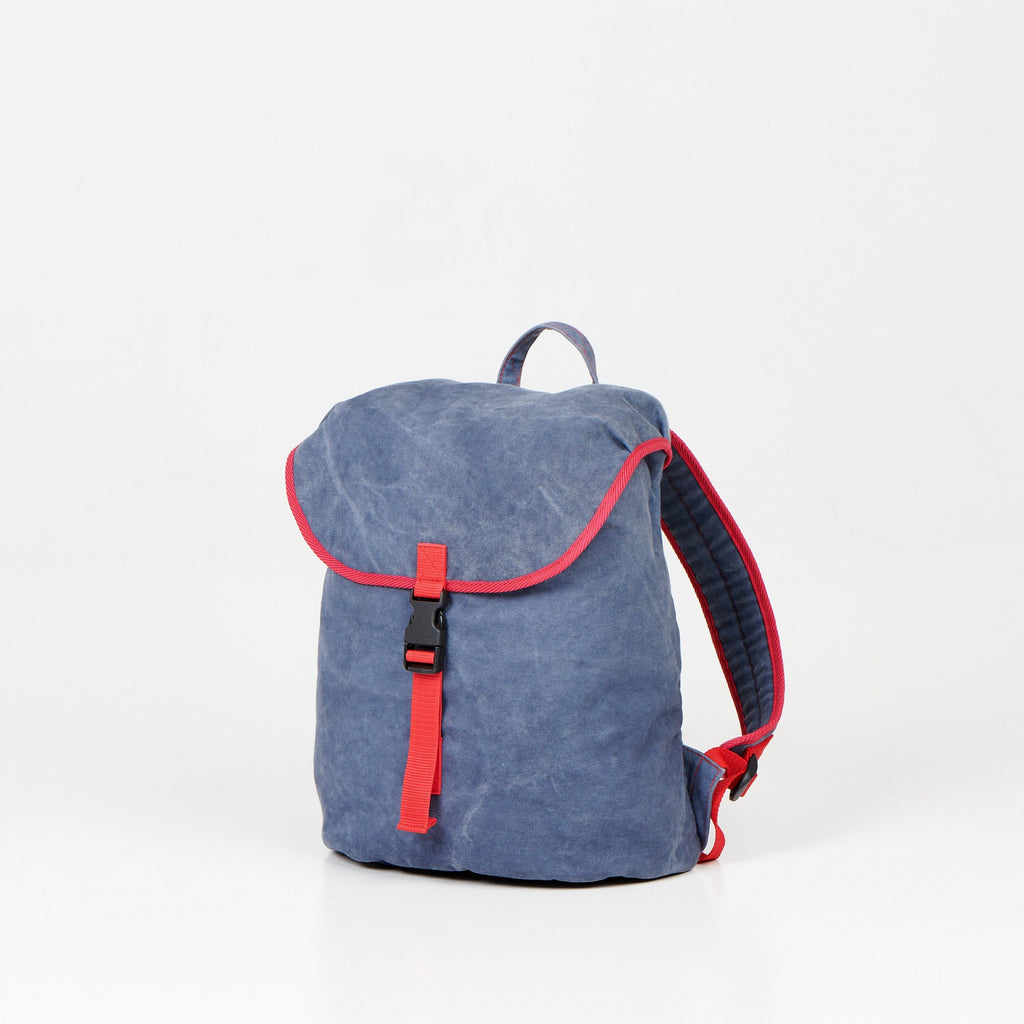 4. Angled view of Noel Walker 12L backpack showcasing compact design and red detailing