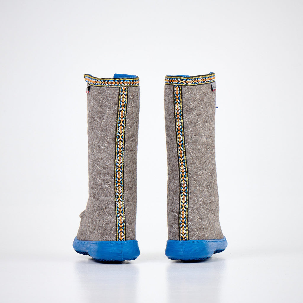 2. Back view of Nesna Lobben Polar Lobben Felt Boots in grey with decorative trim and blue soles, studio shot