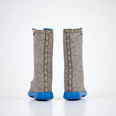 2. Back view of Nesna Lobben Polar Lobben Felt Boots in grey with decorative trim and blue soles, studio shot