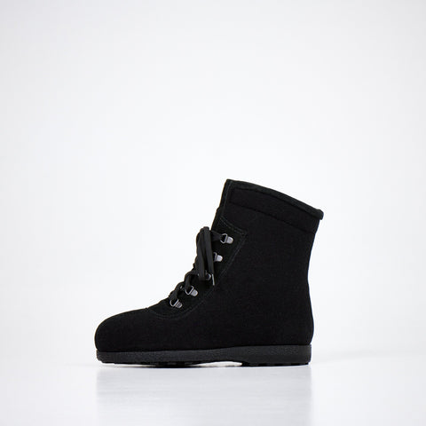 1. Studio shot of Nesna Lobben black felt boots, side view showing lace-up design and polyurethane moulded soles