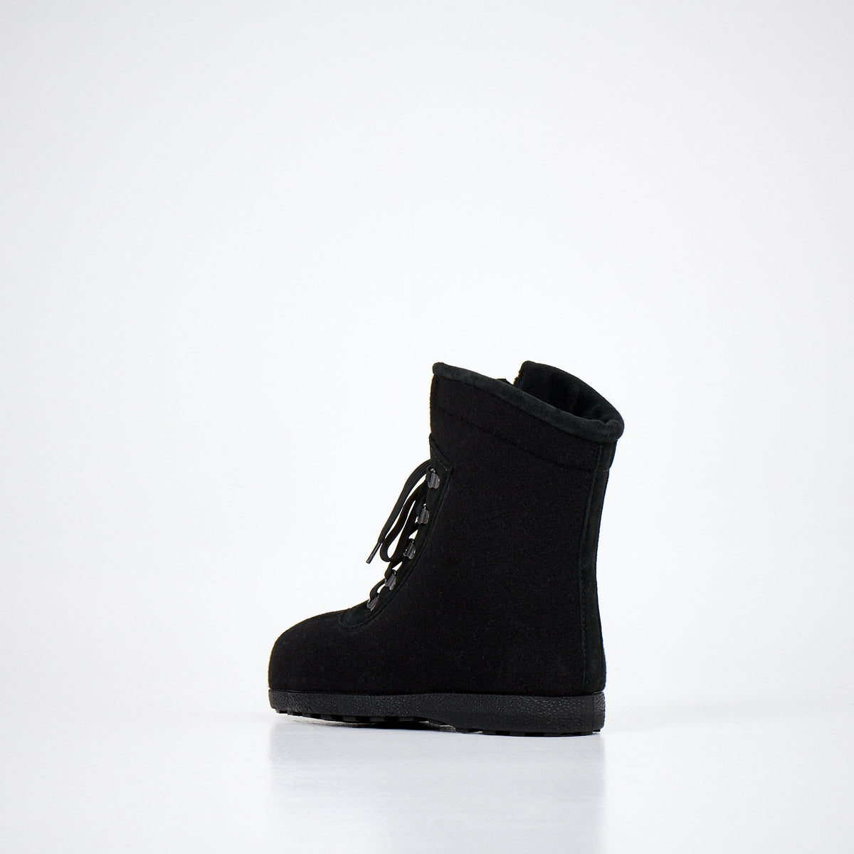 4. Side view of Nesna Lobben black felt boots, emphasizing lightweight design and wool felt construction