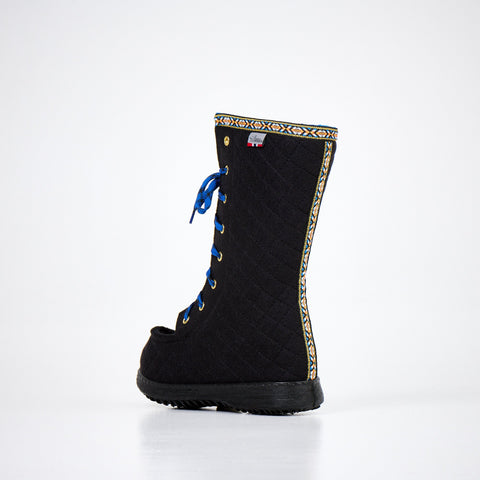 5. Side view of Nesna Lobben Polar Lobben Felt Boots in black with decorative trim, studio setting