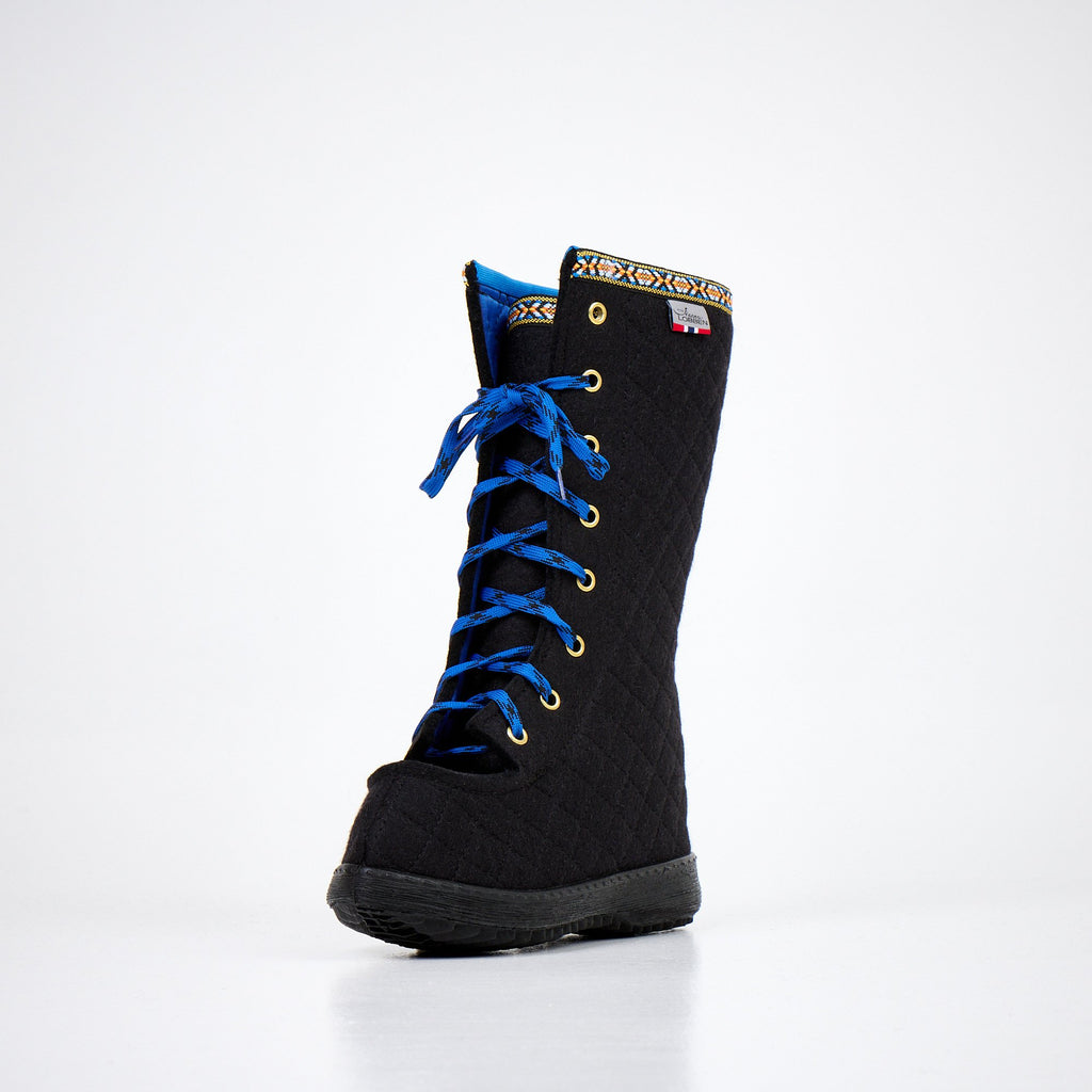 4. Front angled view of Nesna Lobben Polar Lobben Felt Boots in black with blue laces, studio setting