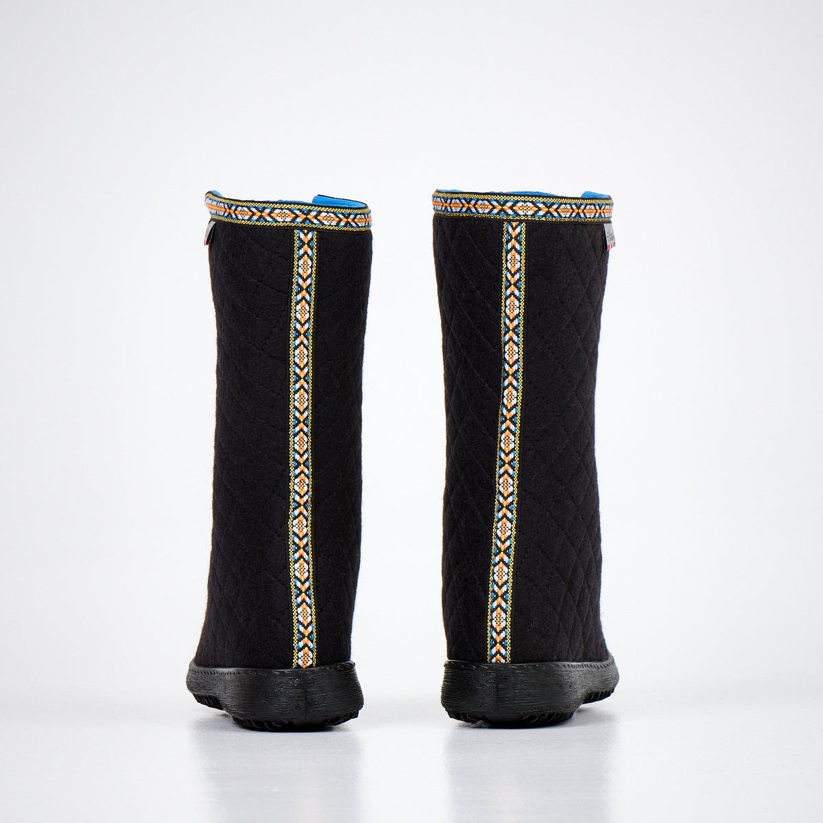 1. Back view of Nesna Lobben Polar Lobben Felt Boots in black with decorative trim, studio setting