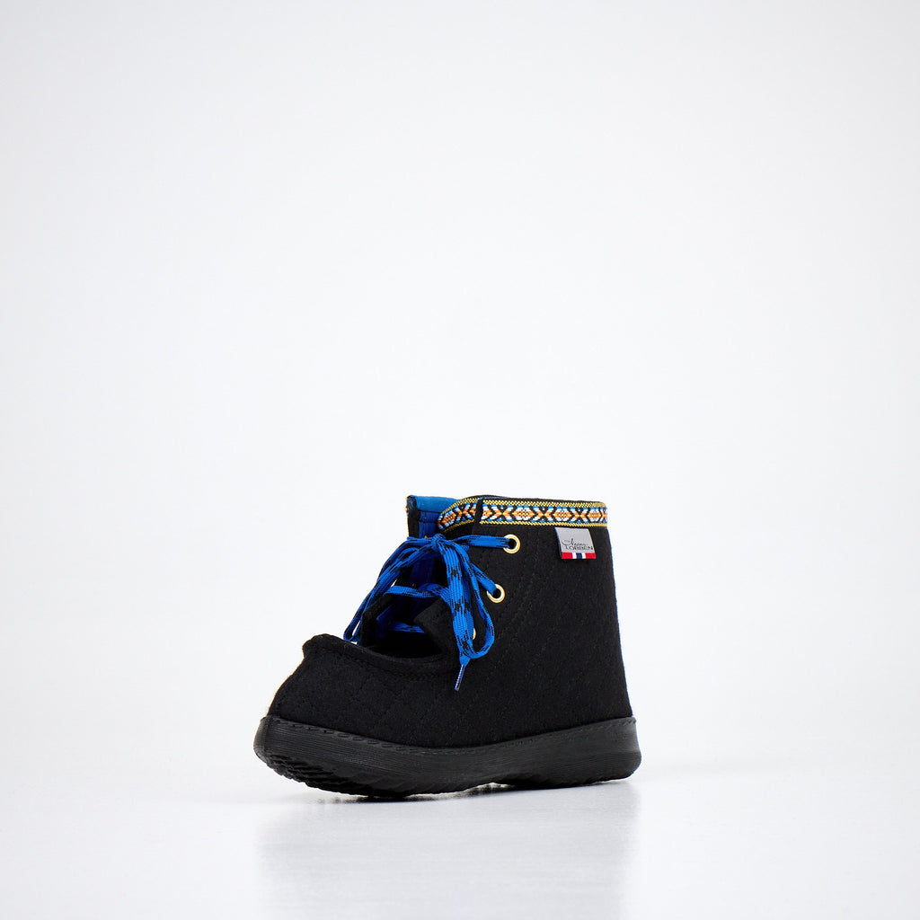 2. Front view of Nesna Lobben black felt boots with blue laces and decorative trim, highlighting wool material