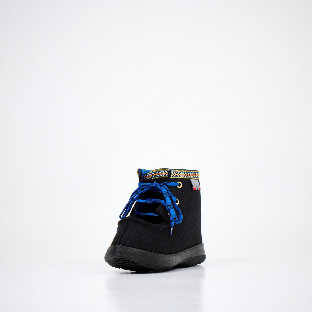 1. Studio side view of Nesna Lobben black felt boots with blue laces and patterned trim, showcasing polyurethane sole