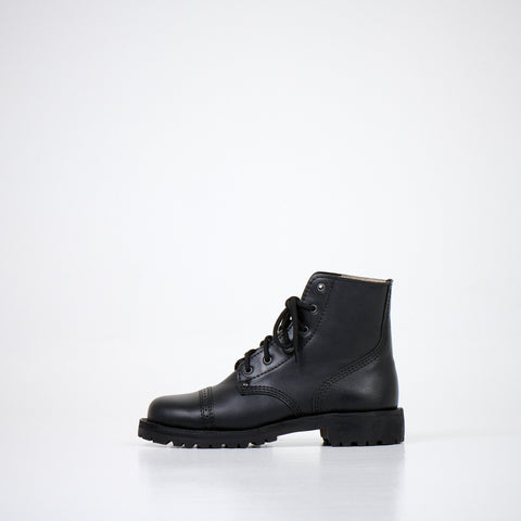 3. Side profile of AIPI A-PS-2 black boots, featuring natural leather upper and EVA insole, shown in studio