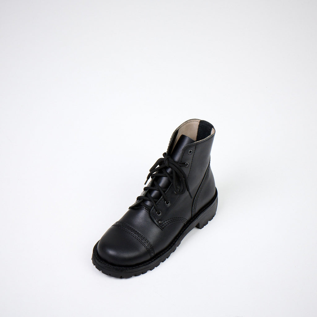 4. Top angled view of AIPI A-PS-2 black boots, emphasizing lace-up closure and sturdy construction in studio