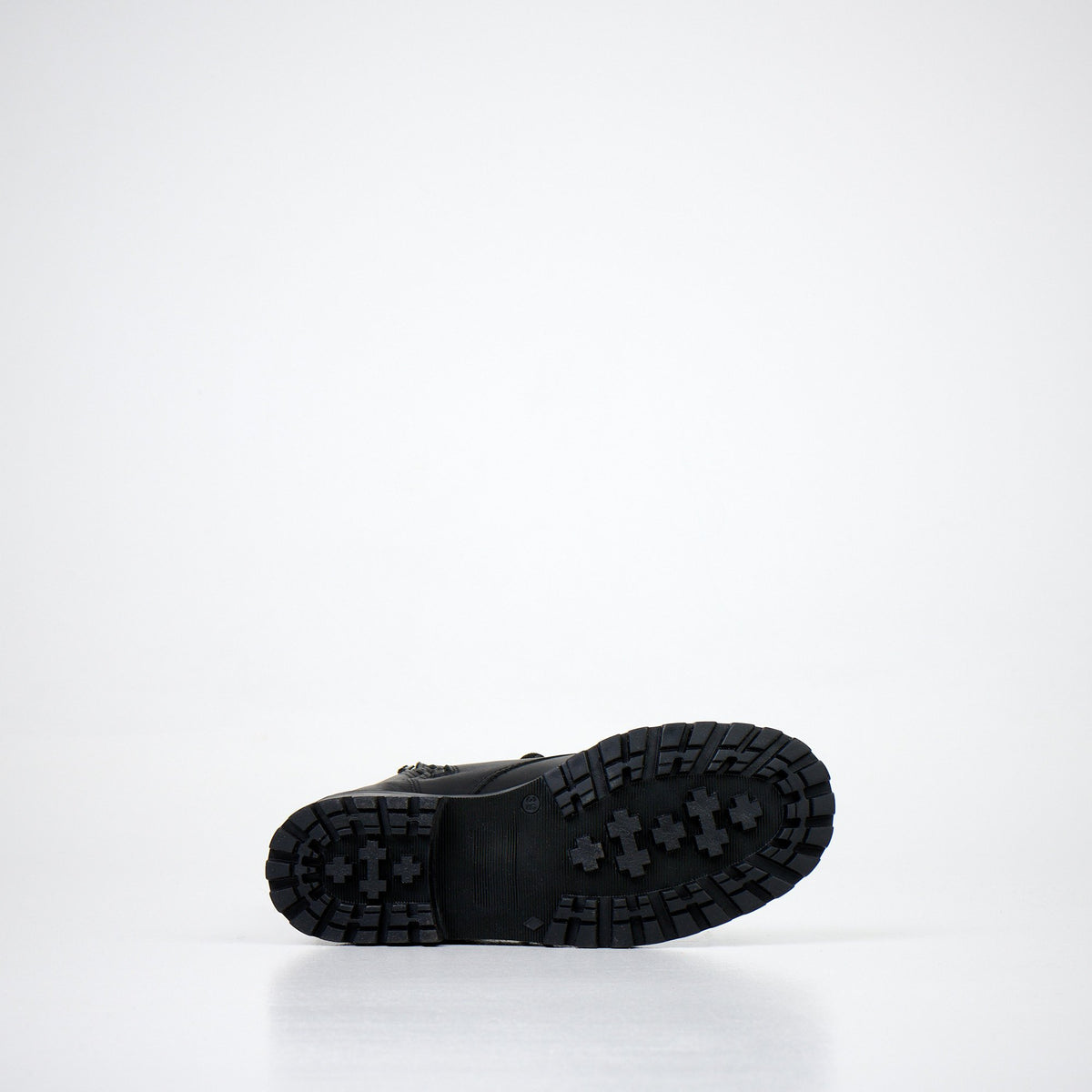3. Close-up of black boot outsole with rugged tread pattern on white background
