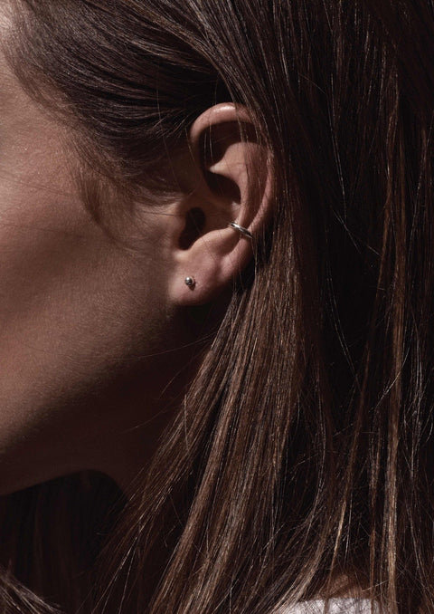 2. Close-up of woman's ear adorned with NO MORE Pin Up Earrings in sterling silver, highlighting delicate bubble design