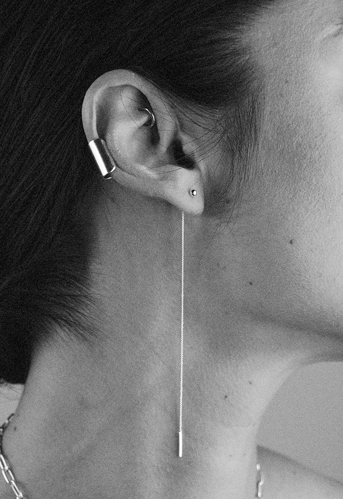 2. Close-up of woman wearing NO MORE Pin Up Threader Chain Earrings in silver, highlighting the thread-through design
