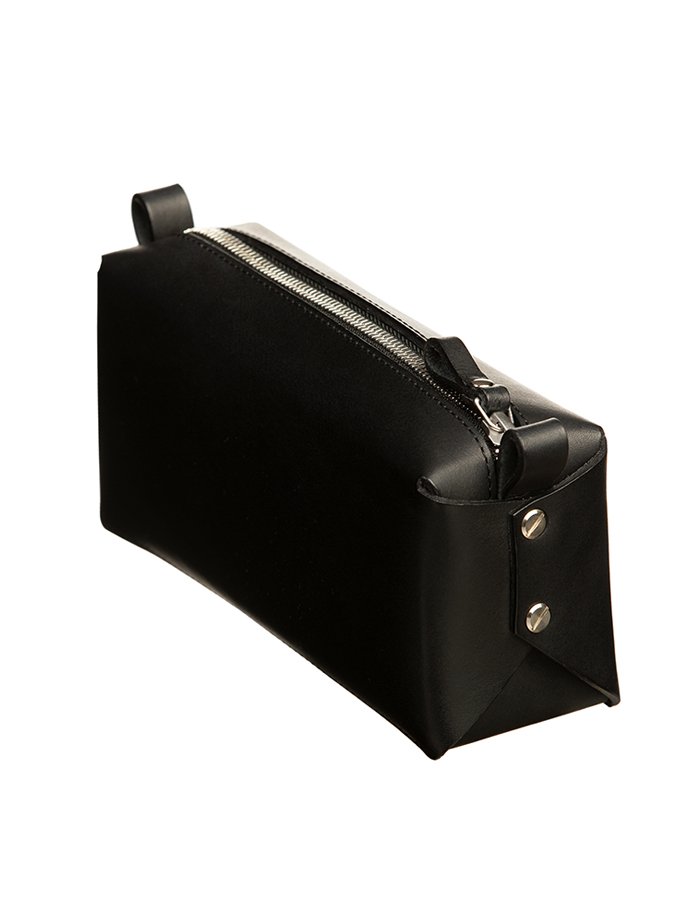3. Black leather makeup bag by Stella Soomlais with silver zipper, angled view showing side rivet details