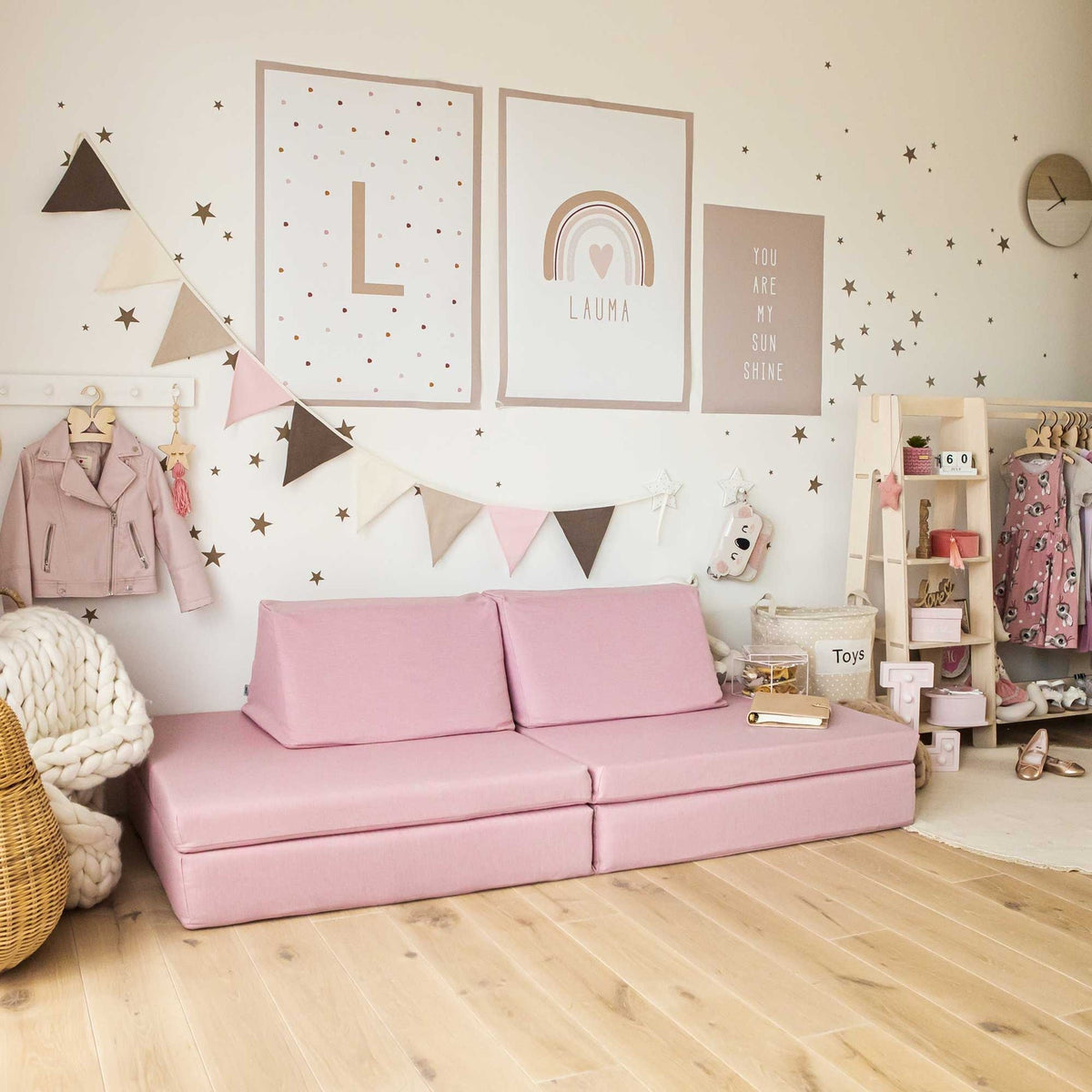 1. Pink play mattress set arranged as a sofa in a decorated room