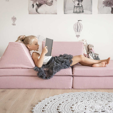 1. Girl lounging on pink play mattress set in a decorated room