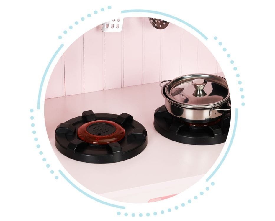 3. Close-up of two black burners on pink play kitchen with a metal pot on one burner