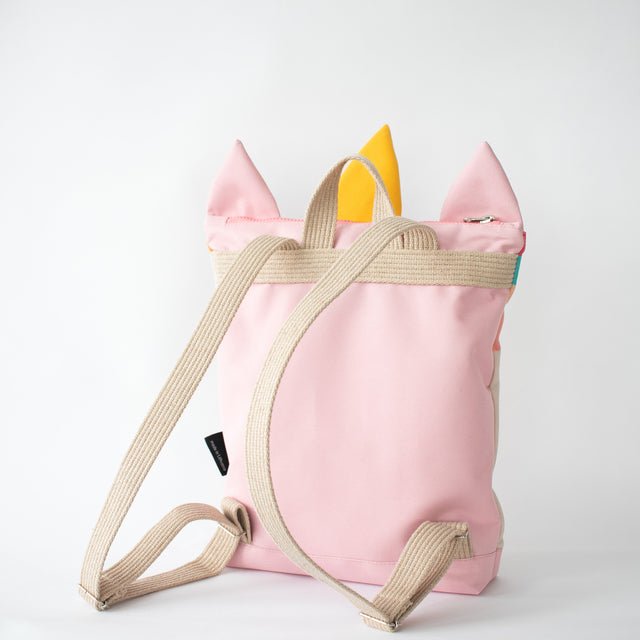 5. Back view of MUNI Unicorn backpack on girl, showing adjustable straps and pink polyester material