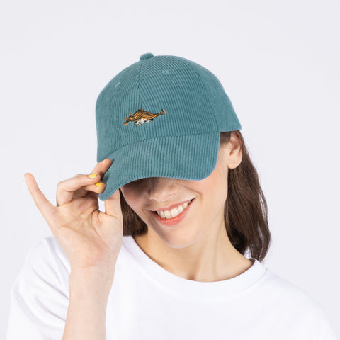 1. Woman wearing Pippi Corduroy Dad Cap in petrol by Moomin, showing front design in studio setting