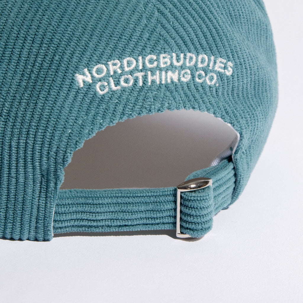 4. Close-up of adjustable strap and NordicBuddies branding on Pippi Corduroy Dad Cap in petrol