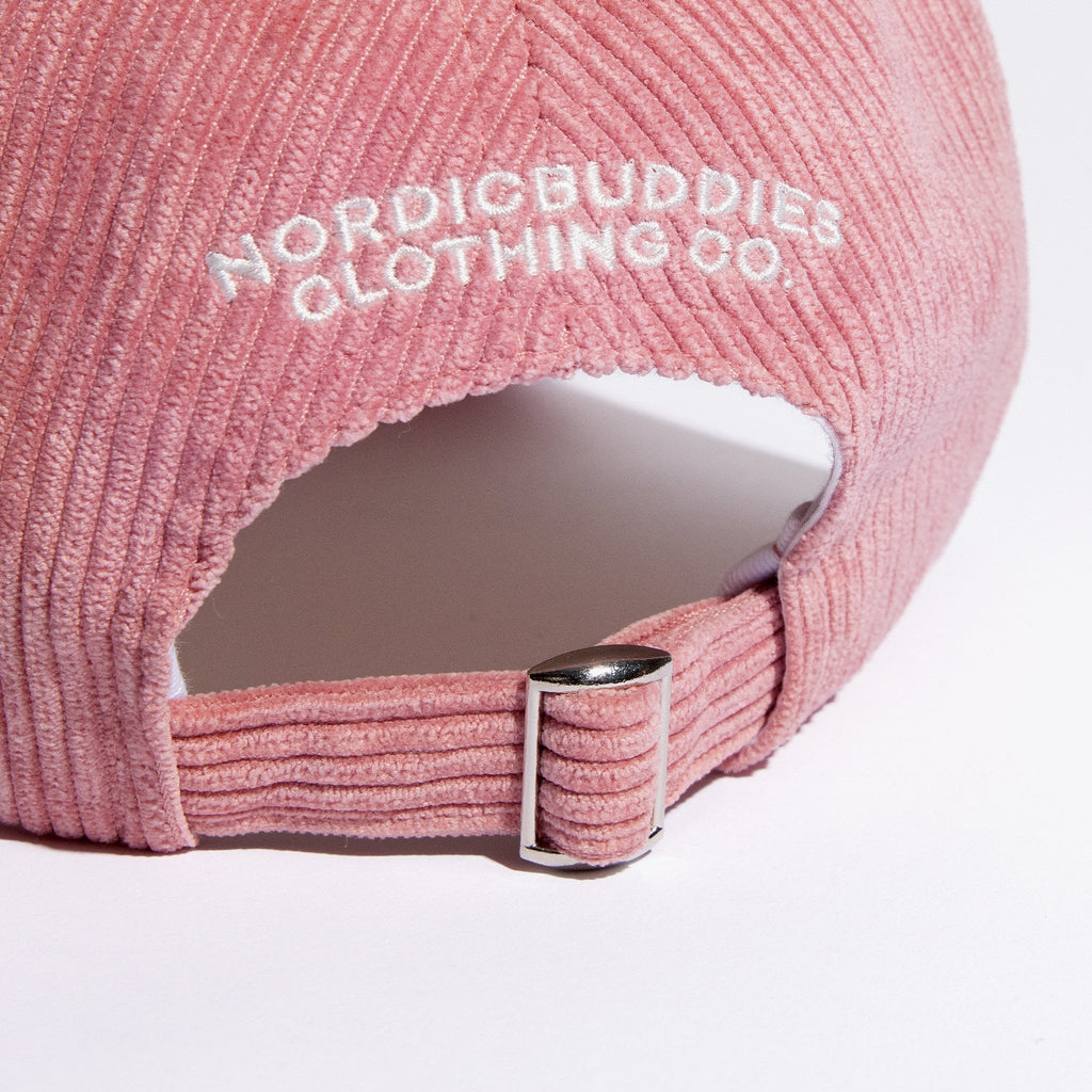 4. Close-up of adjustable strap and NordicBuddies branding on pink corduroy dad cap