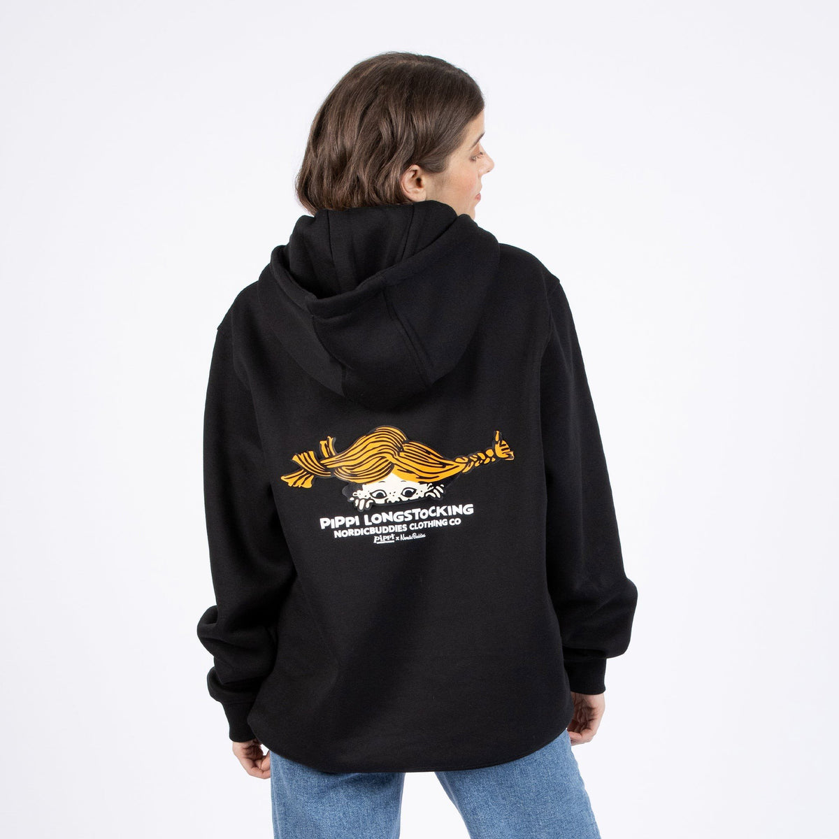 2. Woman showing back view of black Pippi Longstocking unisex hoodie with graphic design, styled with jeans
