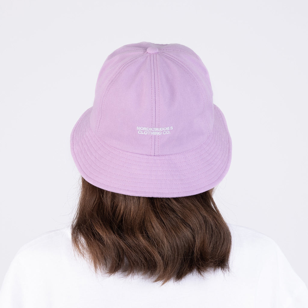 4. Back view of lilac bucket hat with NordicBuddies logo, worn by woman