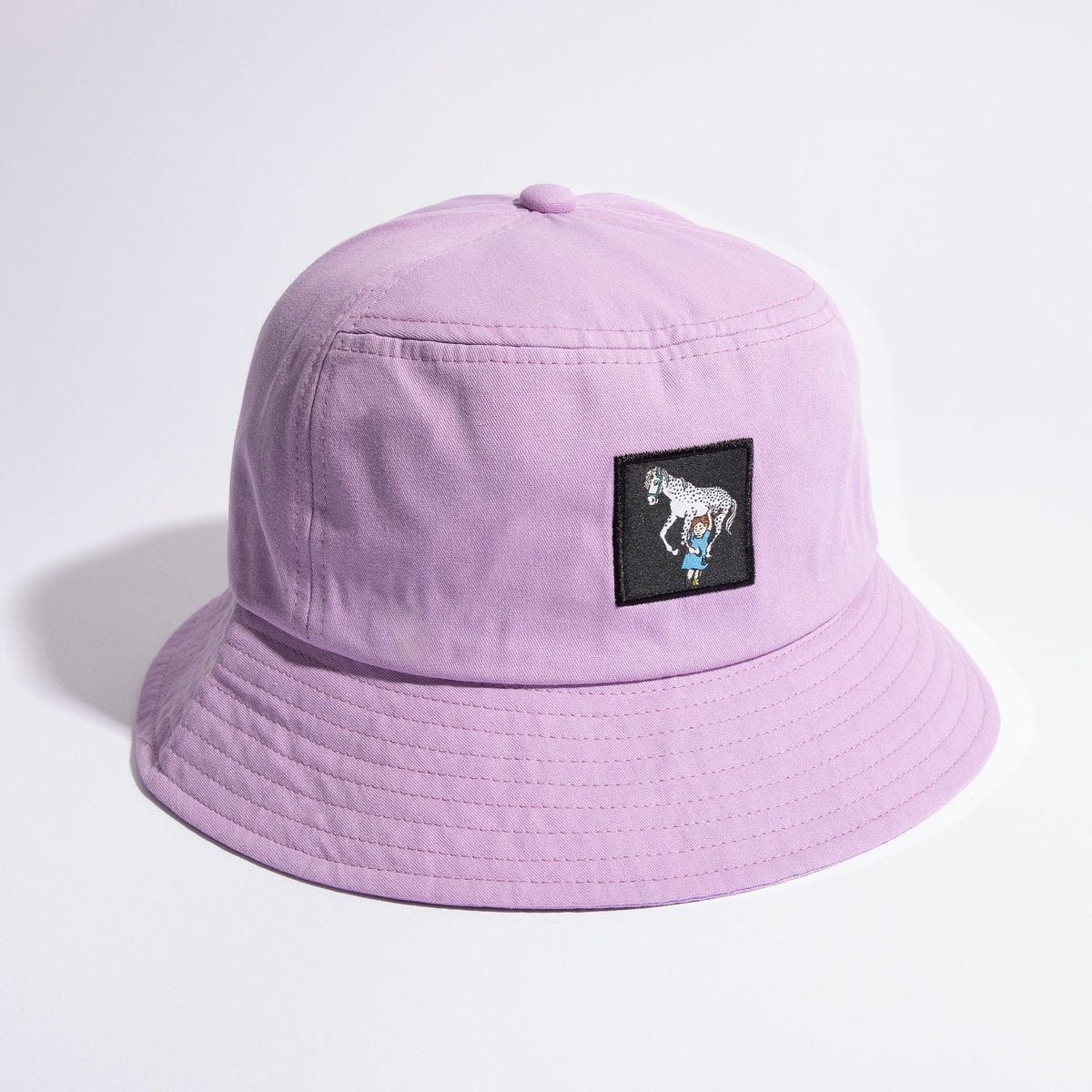 2. Lilac Pippi Longstocking bucket hat with embroidered patch, shown in studio lighting