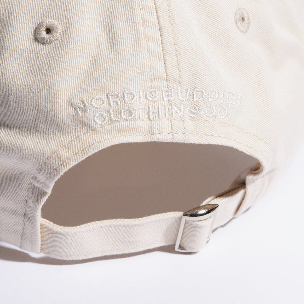 5. Close-up of adjustable strap and NordicBuddies branding on natural white Dad Cap