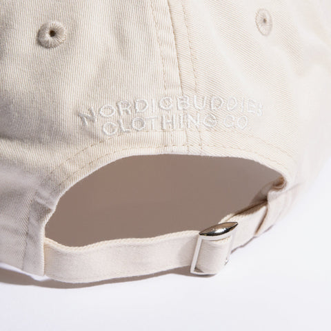 5. Close-up of adjustable strap and NordicBuddies branding on natural white Dad Cap
