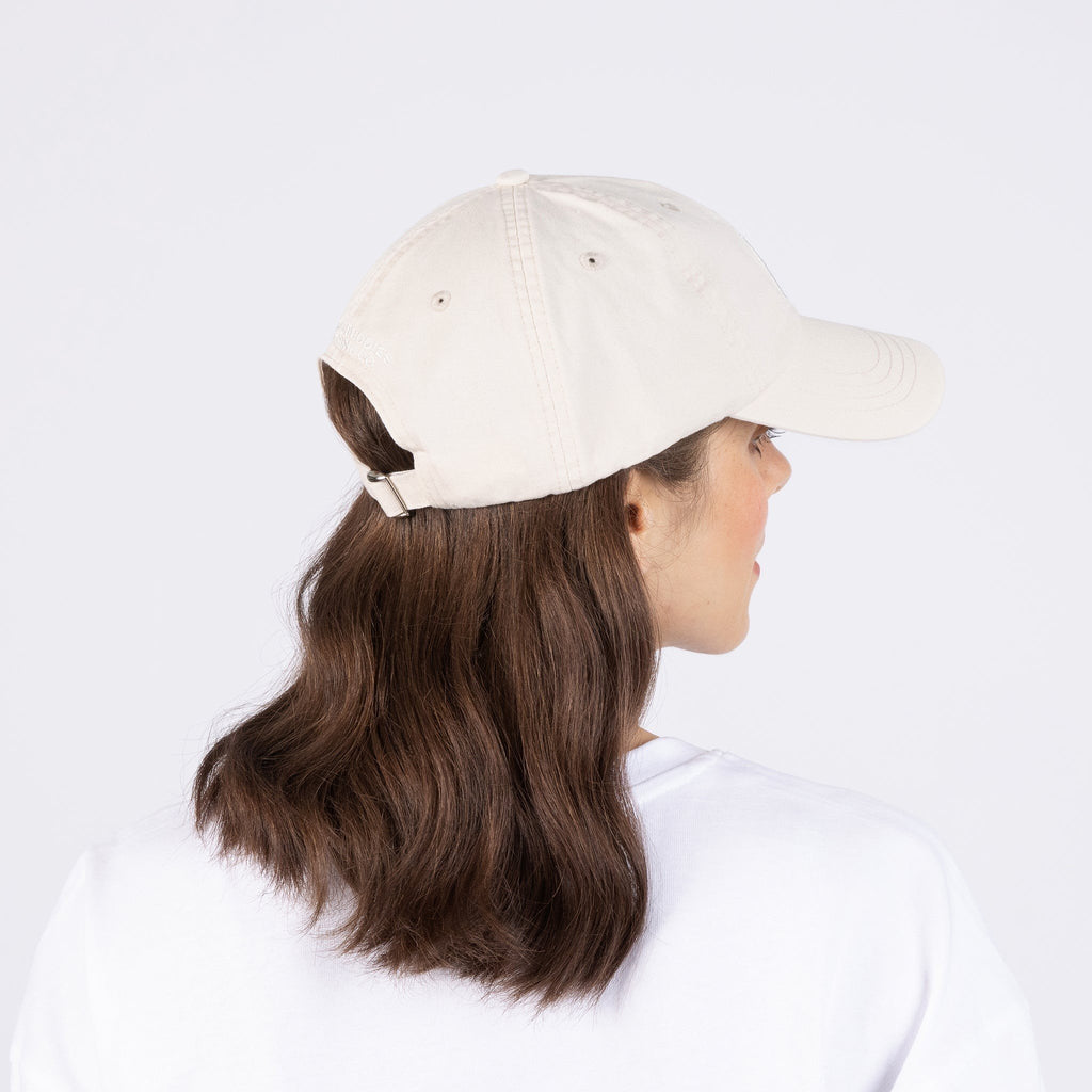 2. Woman wearing Pippi Longstocking Dad Cap in natural white by Moomin, back view