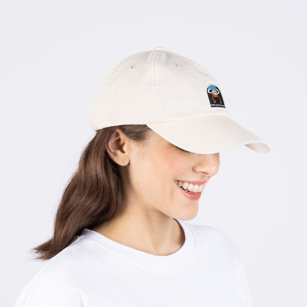1. Woman wearing Pippi Longstocking Dad Cap in natural white by Moomin, side view