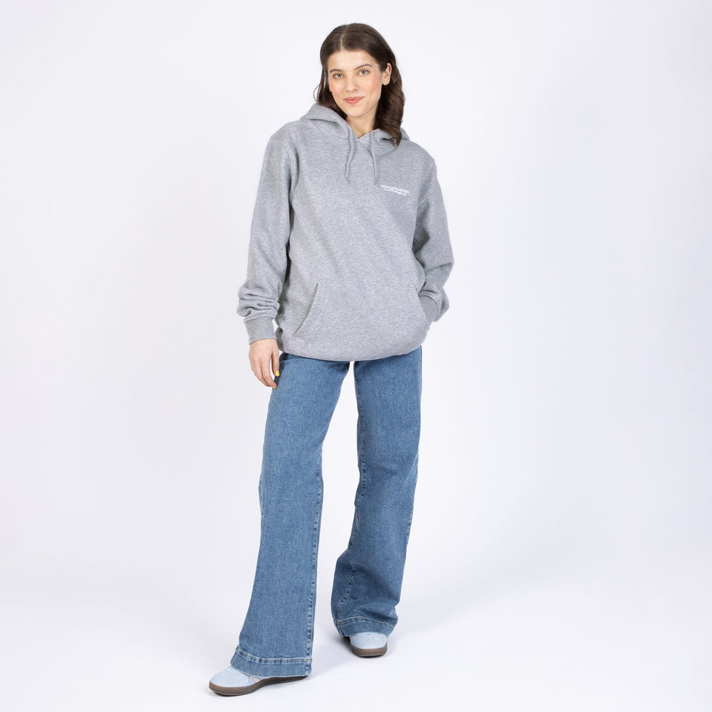 2. Woman wearing Pippi Longstocking unisex heavy hoodie in grey, front view in studio setting