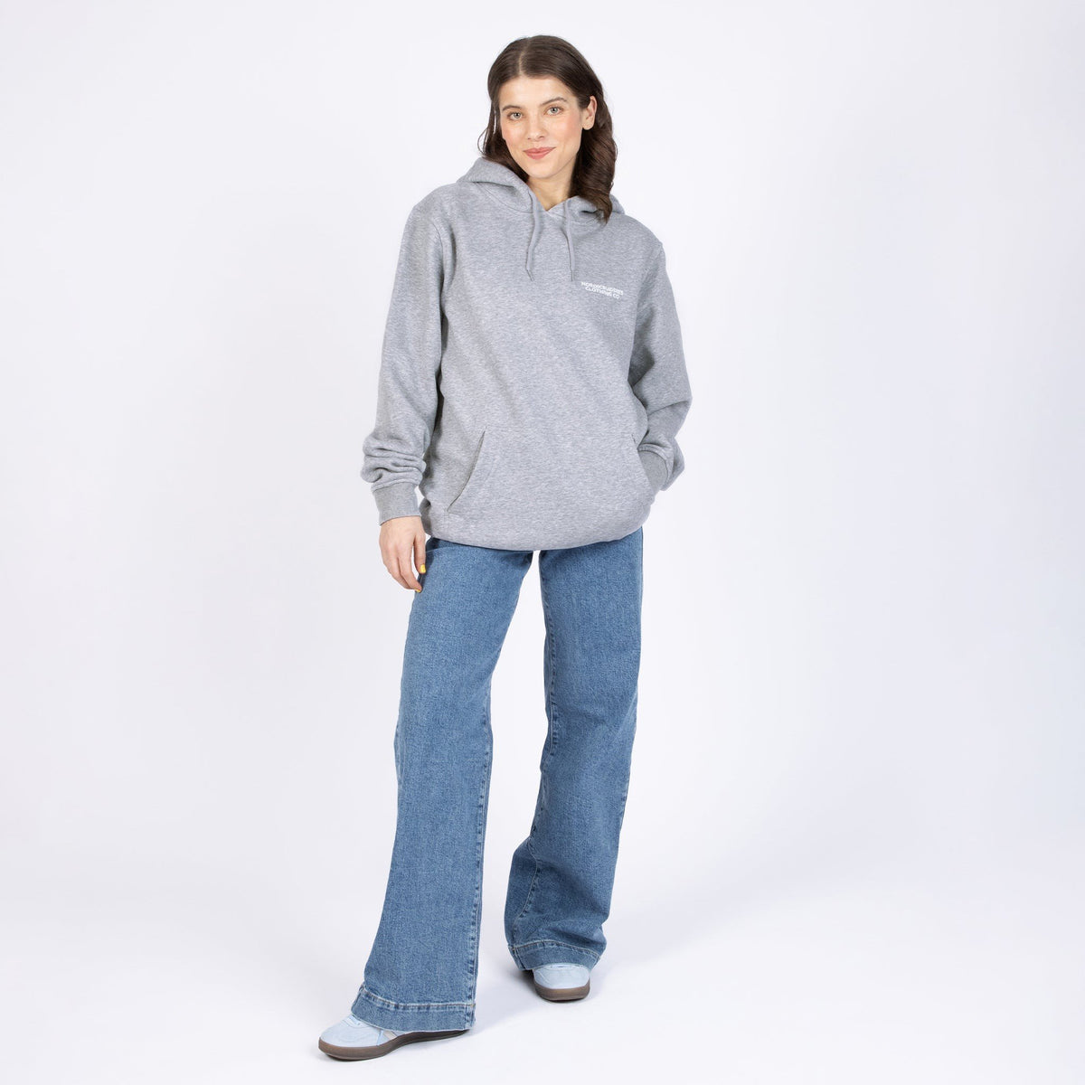 2. Woman wearing Pippi Longstocking unisex heavy hoodie in grey, front view in studio setting