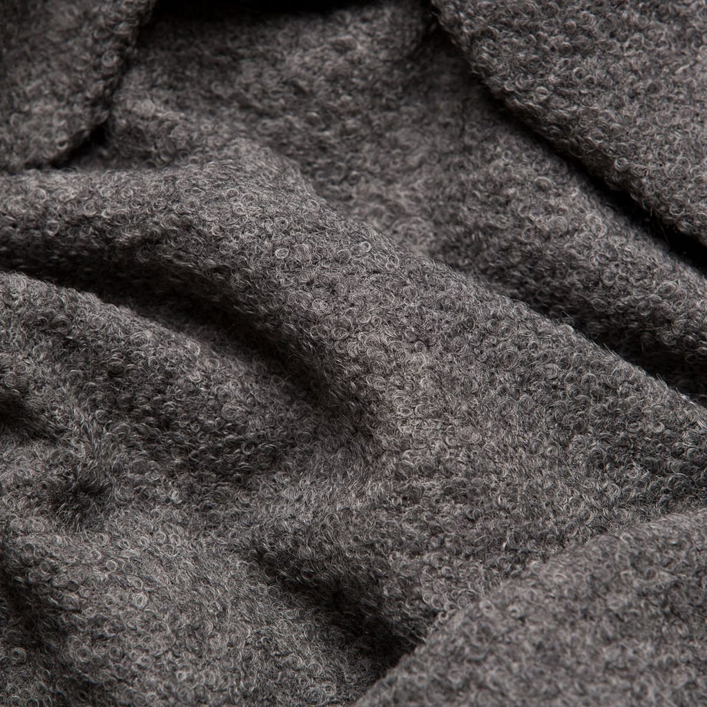7. Close-up of dark grey superfine alpaca wool boucle fabric, highlighting rich texture and quality