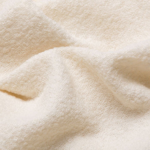 4. Close-up of white superfine alpaca wool boucle fabric, emphasizing soft texture and intricate weave
