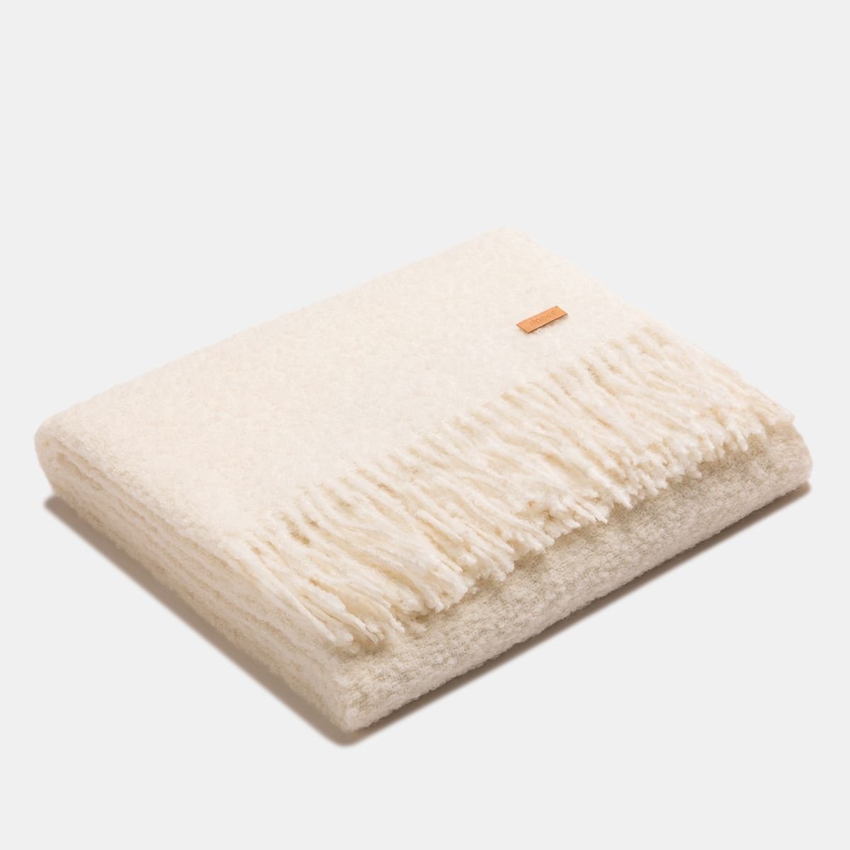 3. Folded white superfine alpaca wool boucle throw with fringe, highlighting plush texture and premium quality