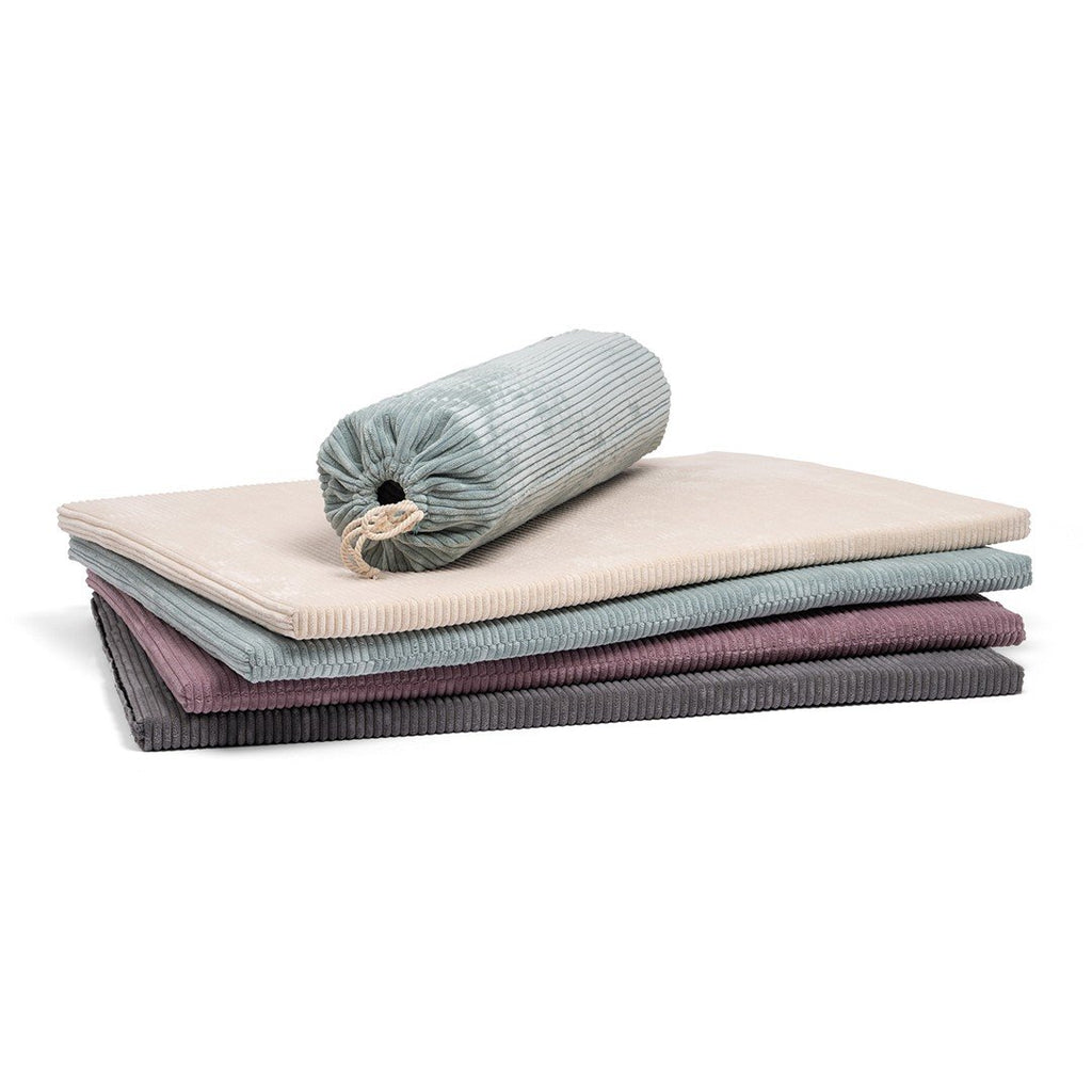 1. Stack of Luula play mats in mint green, cannon pink, milky white, and shadow gray with a rolled mat on top