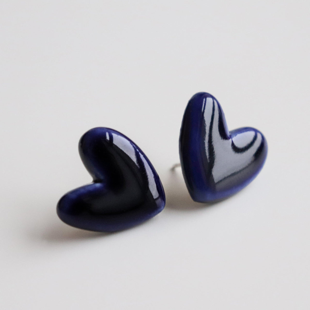 3. Studio shot of Rozenthal blue porcelain heart studs, highlighting glossy finish