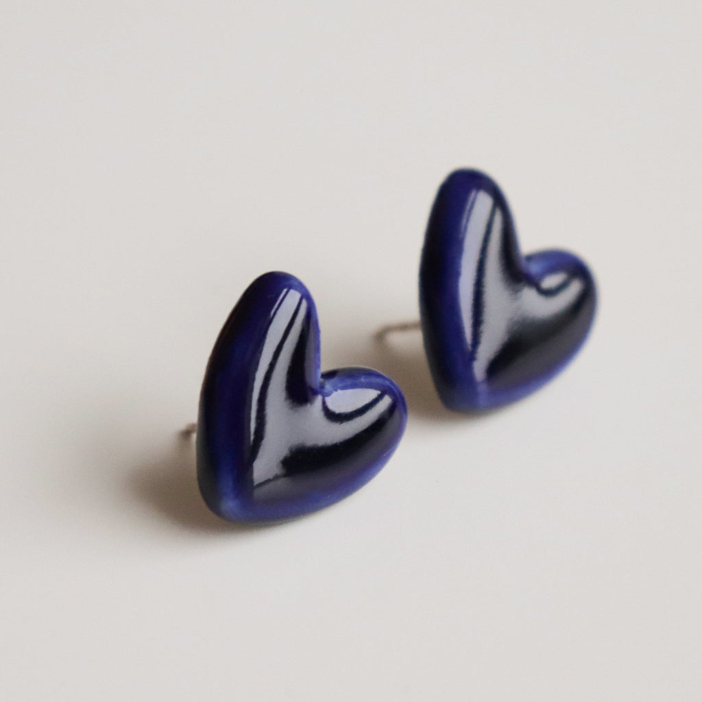 2. Close-up of Rozenthal blue porcelain heart earrings with sterling silver studs