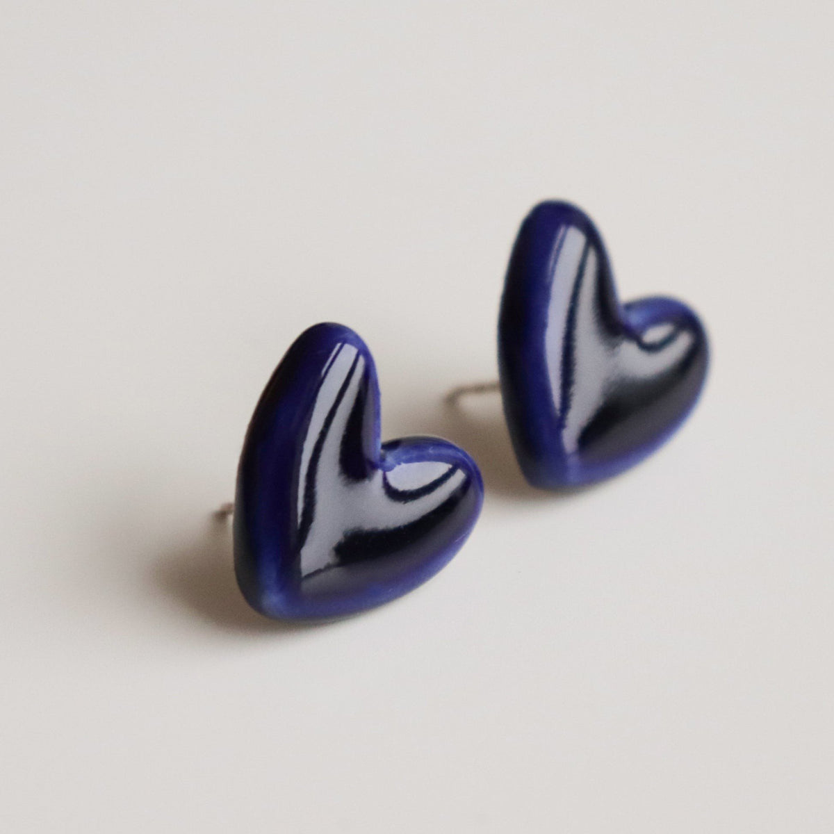 2. Close-up of Rozenthal blue porcelain heart earrings with sterling silver studs