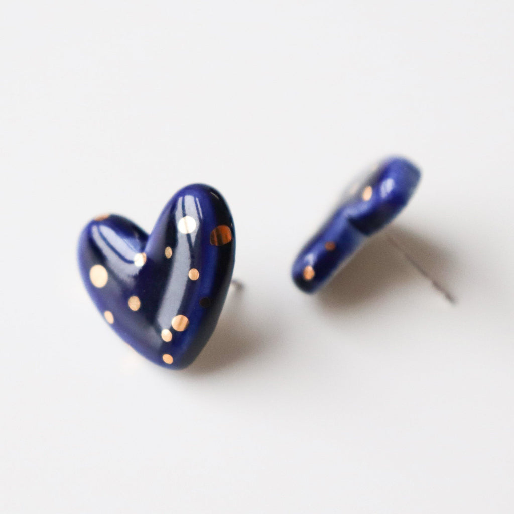 4. Close-up of Rozenthal blue porcelain heart earrings with gold dots, highlighting craftsmanship