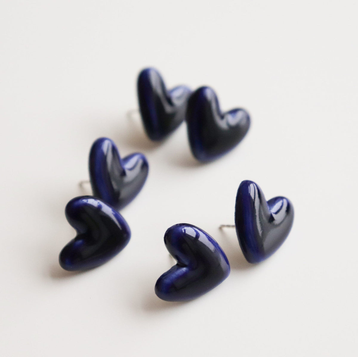 5. Collection of Rozenthal blue and white porcelain heart studs, displayed in studio