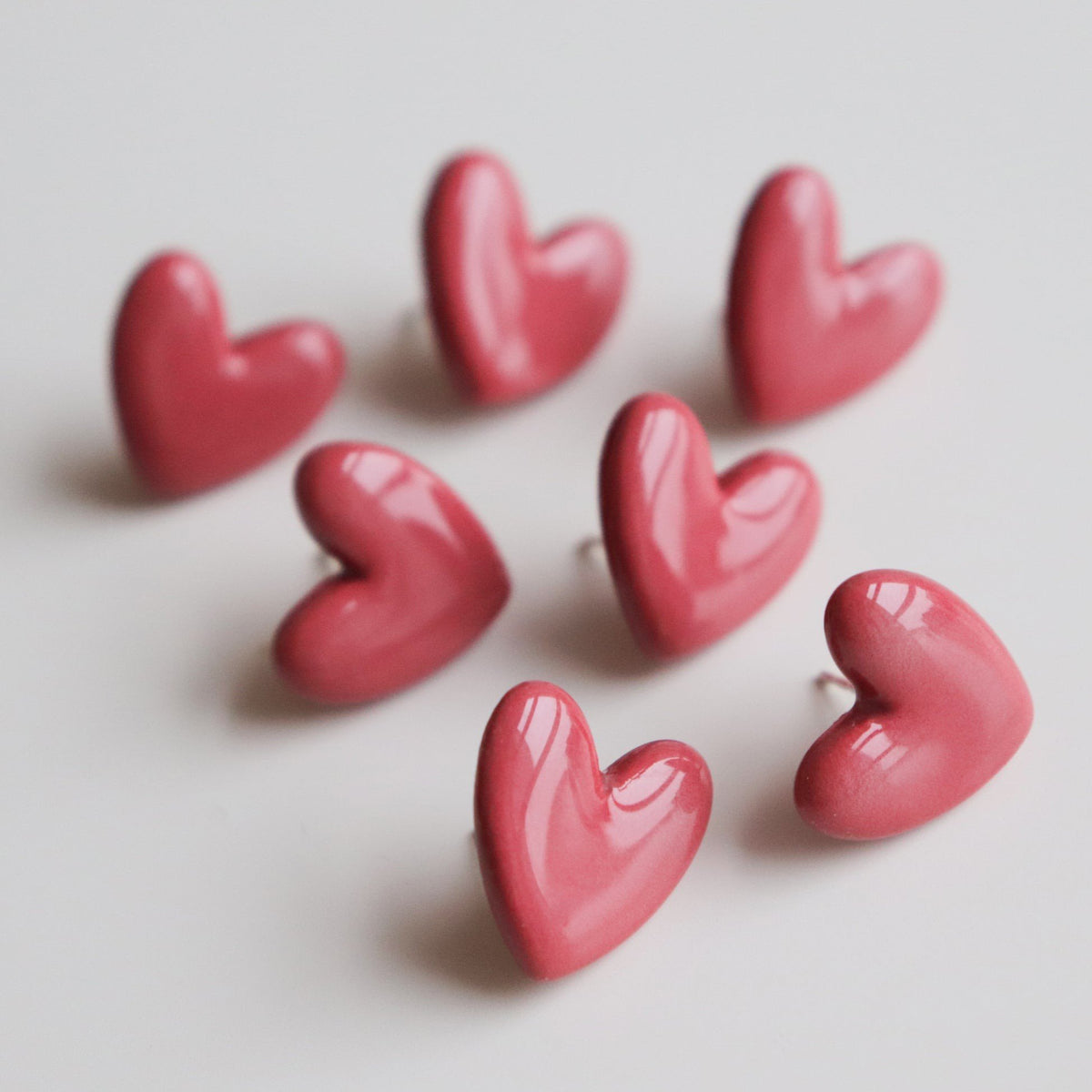 5. Multiple Rozenthal pink porcelain heart earrings with sterling silver studs in a group display