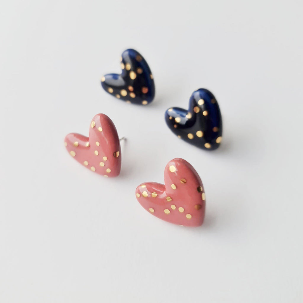 3. Studio shot of Rozenthal blue and pink porcelain heart studs with gold dots, showcasing design variety