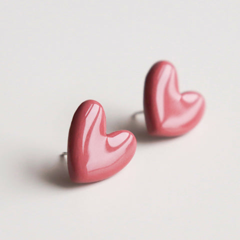 2. Close-up of Rozenthal pink porcelain heart earrings with sterling silver studs