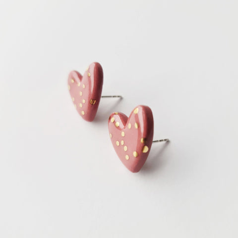 4. Studio image of Rozenthal pink dotted porcelain heart studs with 24k gold accents, shown from side