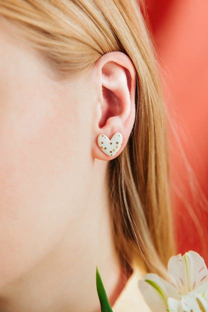 1. Woman wearing Rozenthal Porcelain Heart Studs in white, showcasing elegant design and sterling silver setting